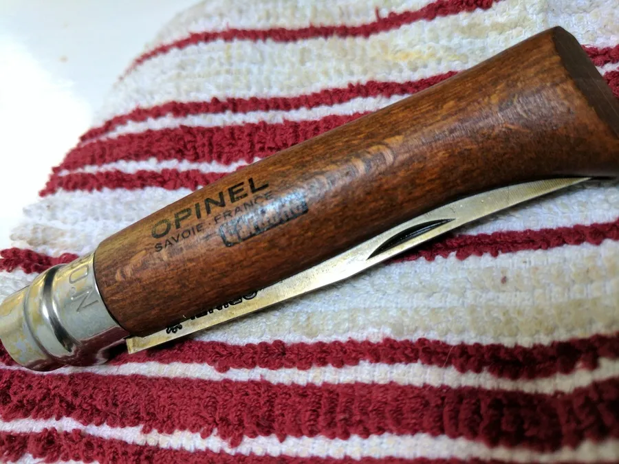 Opinel No.8 open on a wood surface