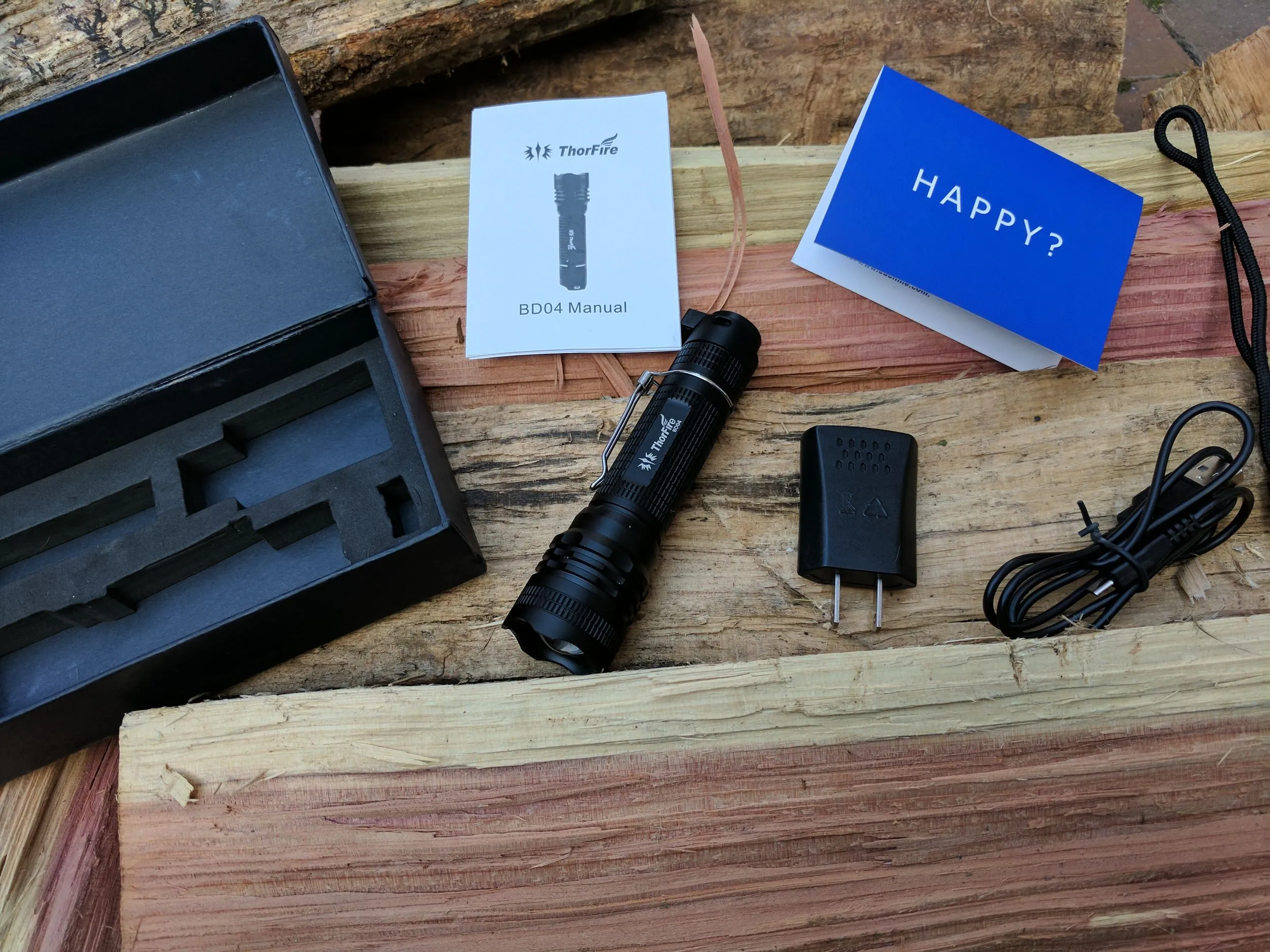 ThorFire BD05 flashlight shown next to its packaging