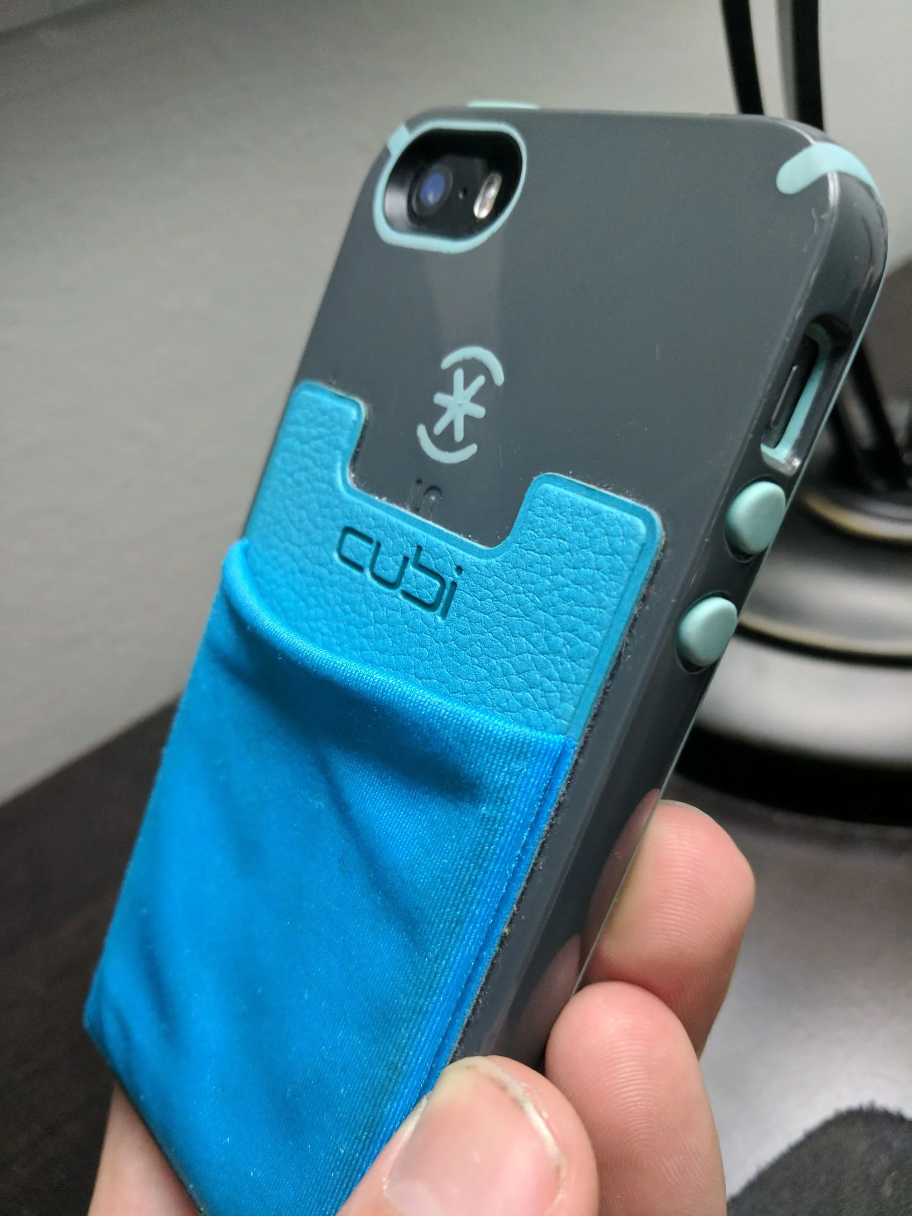 CardNinja adhesive card holder attached to the back of a phone