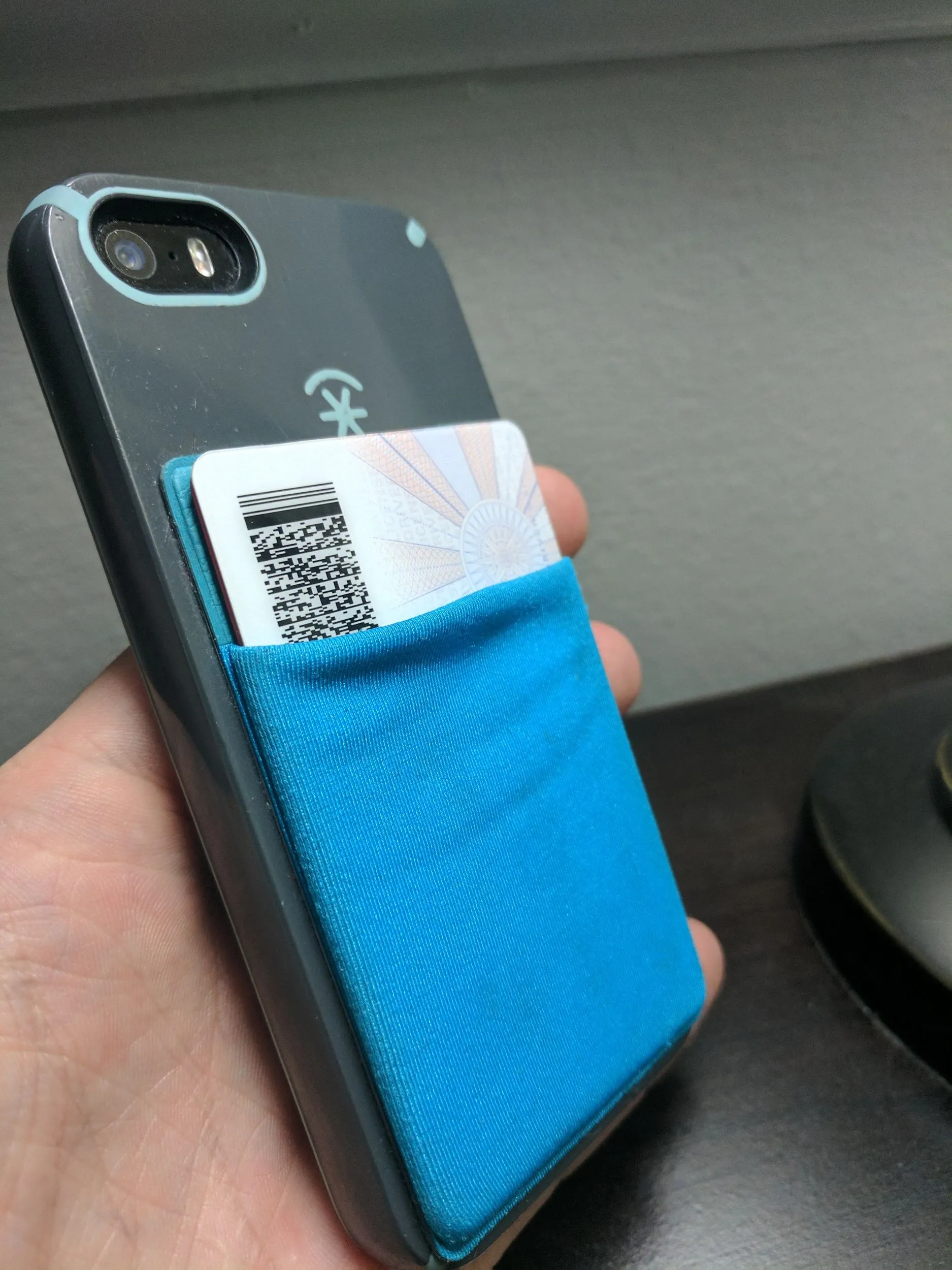Phone with CardNinja held in hand showing added bulk